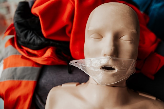 Close up ife size training dummy model doll face detail mannequin mouth wide open medical equipment Paramedic class training simple props abstract concept