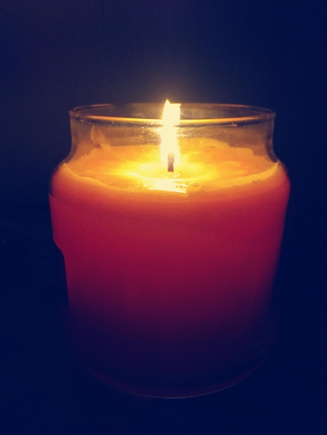 close-up of illuminated candle against black background