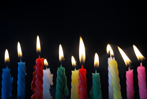 close-up of illuminated candles against black background
