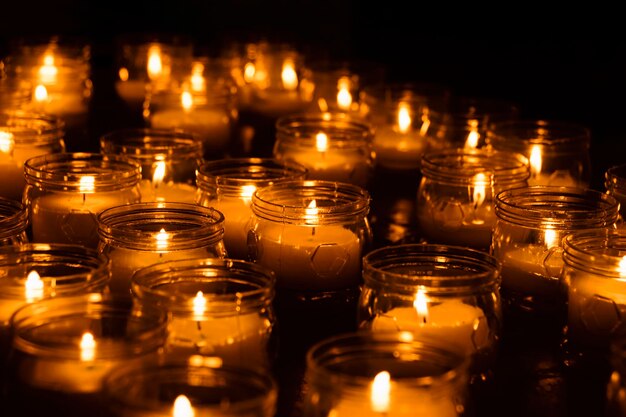 Close-up of illuminated candles in jar