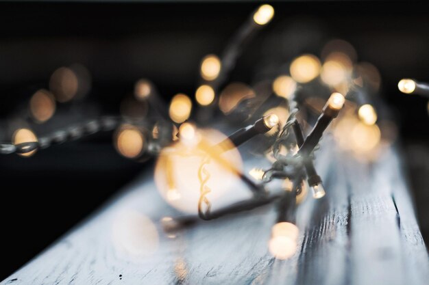 Photo close-up of illuminated christmas lights on table