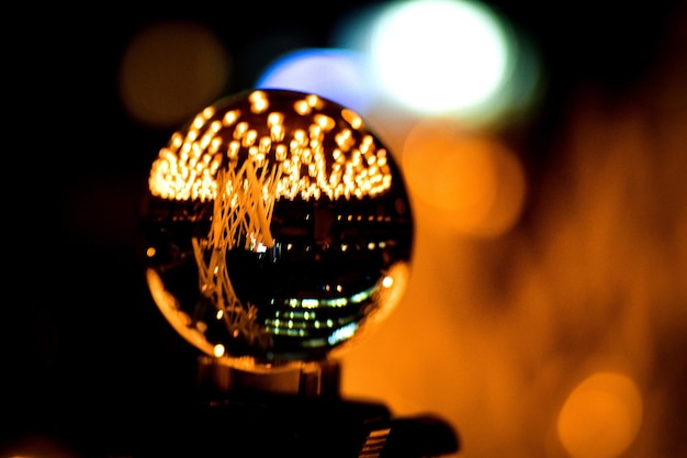 Photo close-up of illuminated crystal ball at night