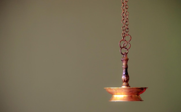 Close-up of illuminated electric lamp against wall