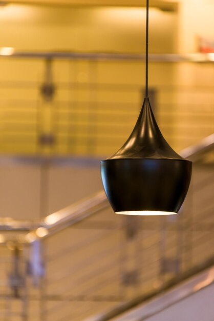 Photo close-up of illuminated electric lamp against wall