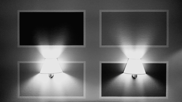 Photo close-up of illuminated electric lamps mounted on wall