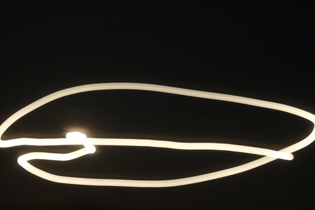 Photo close-up of illuminated lamp over black background