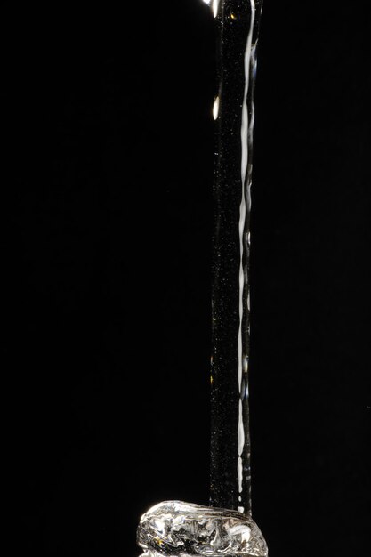 Close-up of illuminated lamp over black background