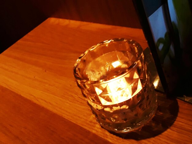 Close-up of illuminated lamp on table