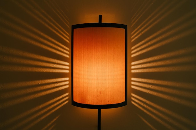 Close-up of illuminated lamp on wall at home