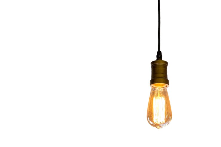 Photo close-up of illuminated light bulb against white background