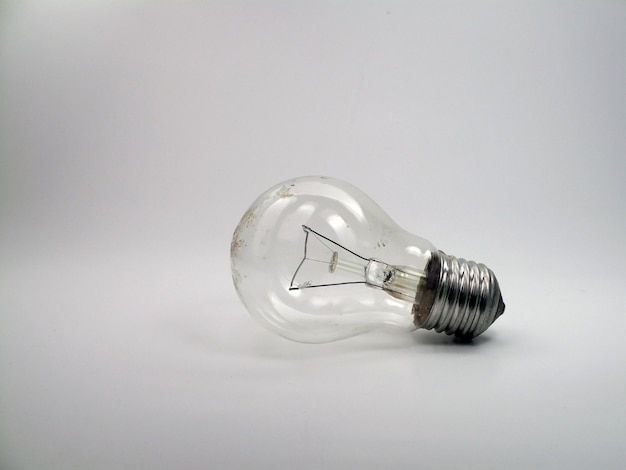 Close-up of illuminated light bulb against white background