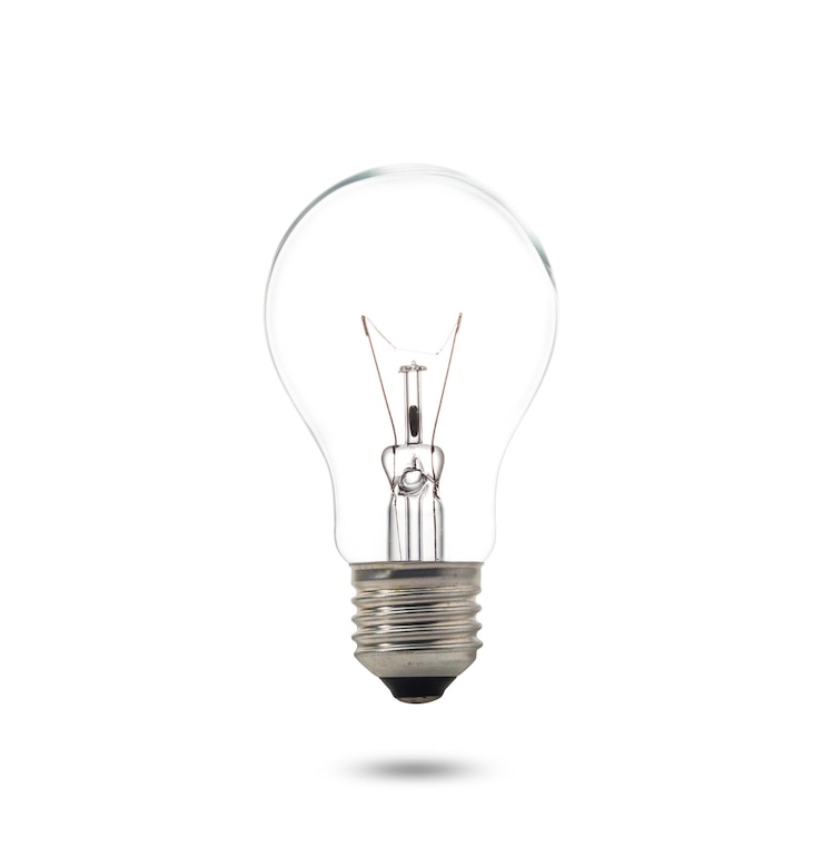 Photo close-up of illuminated light bulb against white background