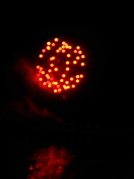 Photo close-up of illuminated light bulb over black background