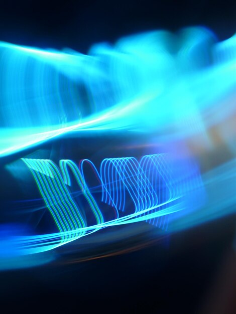 Close-up of illuminated light trails against black background