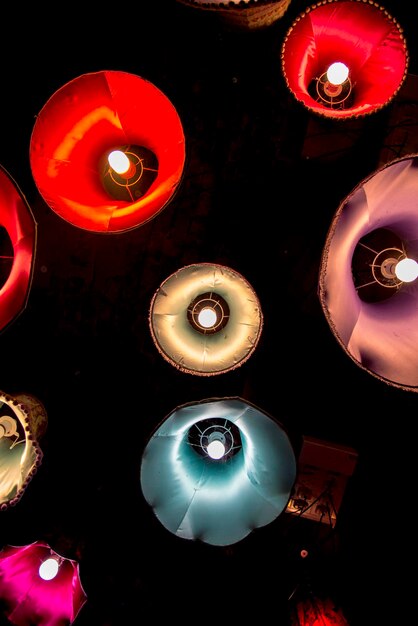 Close-up of illuminated lighting equipment against black background