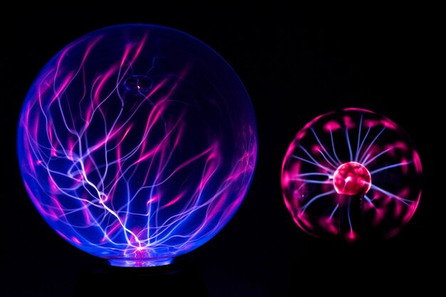 Photo close-up of illuminated lighting equipment against black background