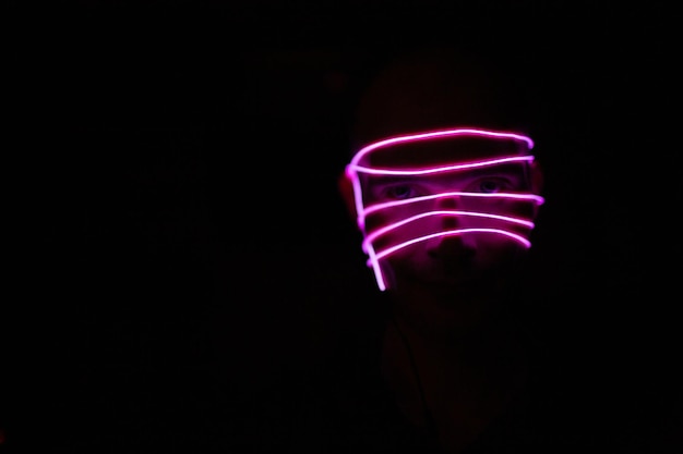 Photo close-up of illuminated lighting equipment against black background