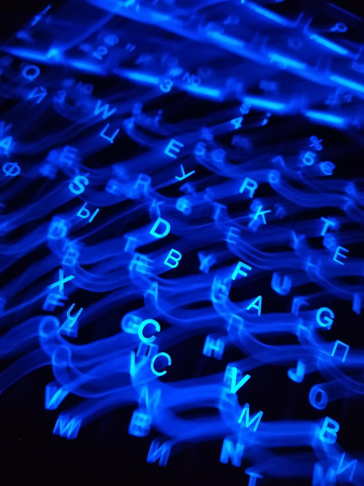 Photo close-up of illuminated lighting painting and letters against black background