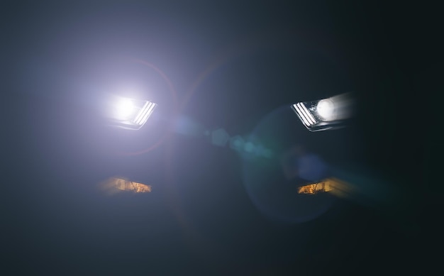 close-up of illuminated lights against sky at night