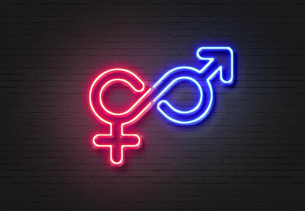 Photo close-up of illuminated male and female symbols on wall