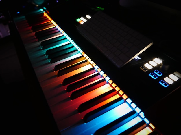 Close-up of illuminated piano in darkroom