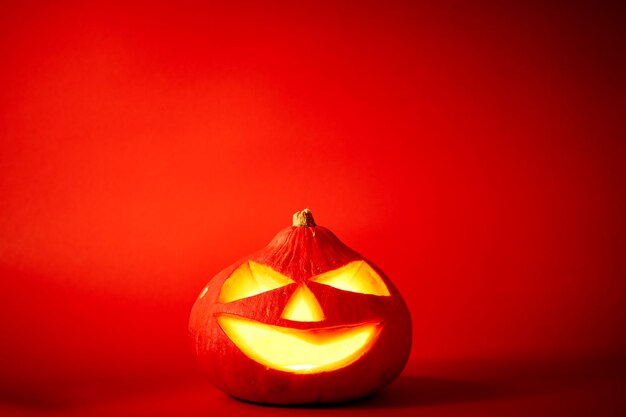 Close-up of illuminated pumpkin against red background