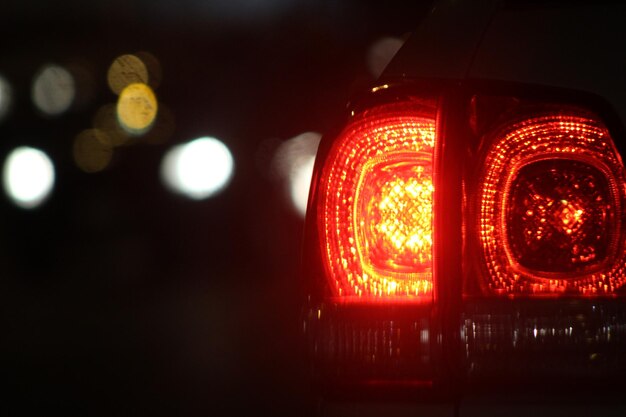 Photo close-up of illuminated red car tail light