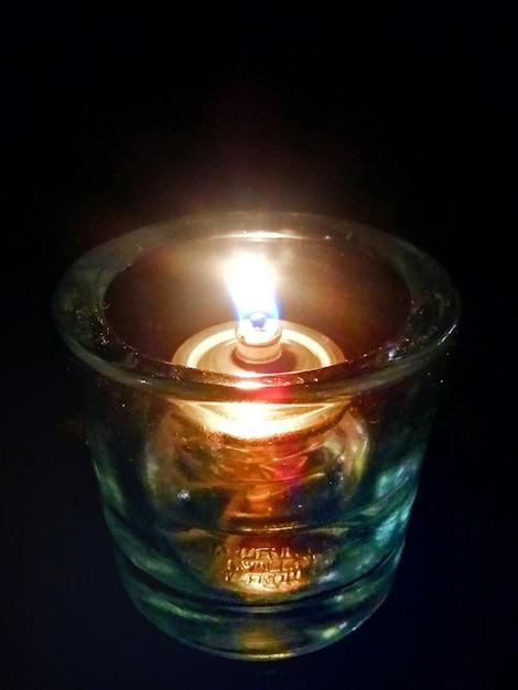 close-up of illuminated tea light against black background