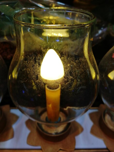 Close-up of illuminated tea light candle on table