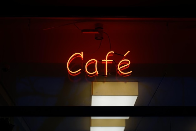 Photo close-up of illuminated text cafe on the wall