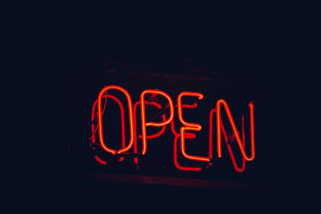 Photo close-up of illuminated text on wall at night