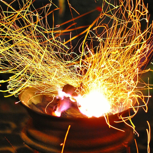 Close-up of illuminated wood in container