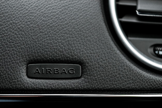 Close up image of the airbag on the steering wheel of a car.- Image