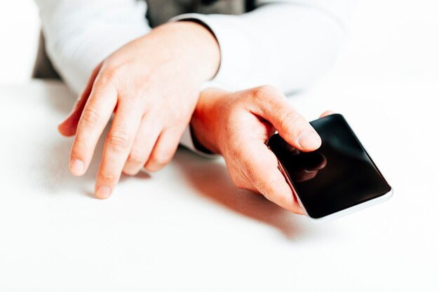 Photo close up image of businessman using a smartphone