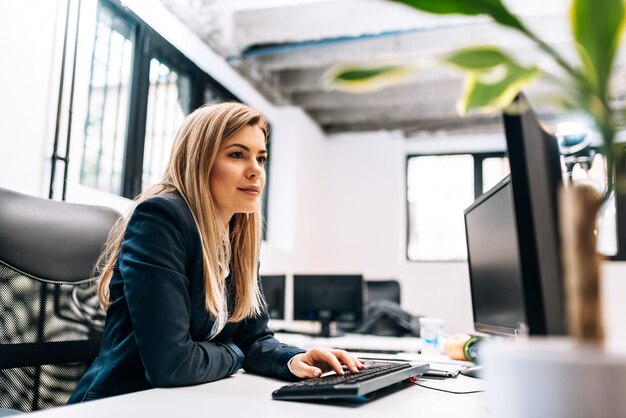 Close-up image of a businesswoman working on the computer.