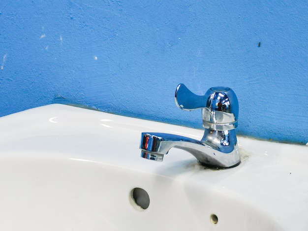 Close up image of dirty chrome fauset sink.