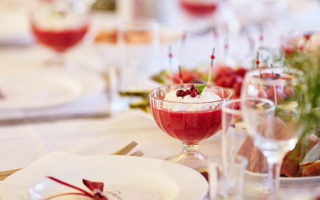 Close-up image of a festive table with sliced fruits and desserts. Festive event, party or wedding reception.