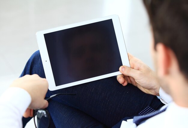 Close-up image of an office worker using a touchpad to analyze statistical data