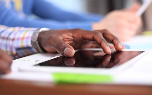 Close up image of an office worker using a touchpad to analyze statistical data