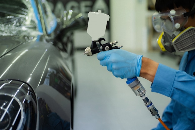 Close-up image of professional car painting, focus on the foreground.