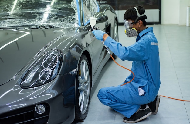 Close-up image of professional car painting, focus on the foreground.