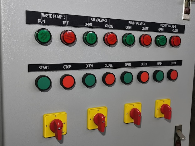 Close up image a row pilot lamp push button and selector switch mount on electrical cabinet door