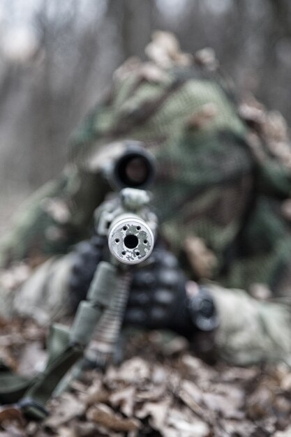 A Camouflaged Sniper Sitting In The Woods Aiming Through His Scope Stock  Photo, Picture and Royalty Free Image. Image 42659284.