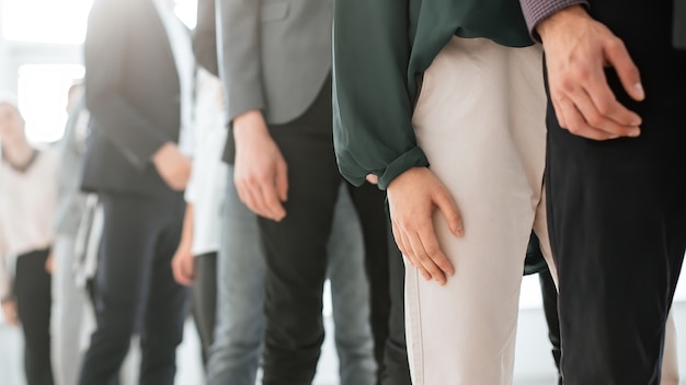 Close up. image of young business people standing in a long queue