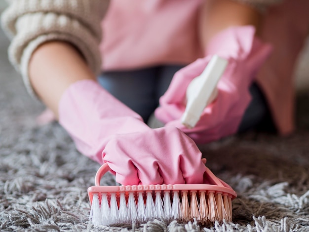 Close-up individual brushing the carpet