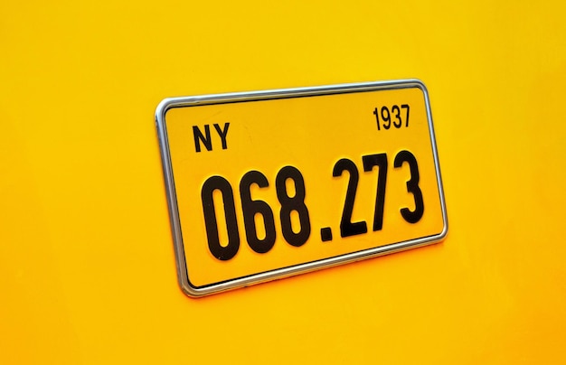 Close-up of information sign against yellow background