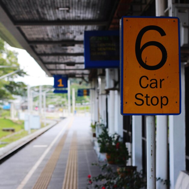 Close-up of information sign at railroad station platform