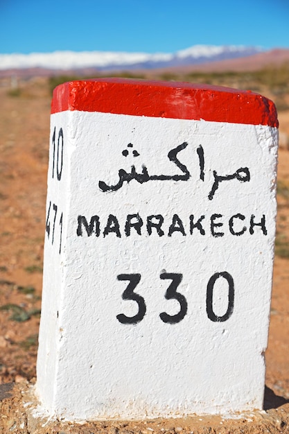 Close-up of information sign on stone at field