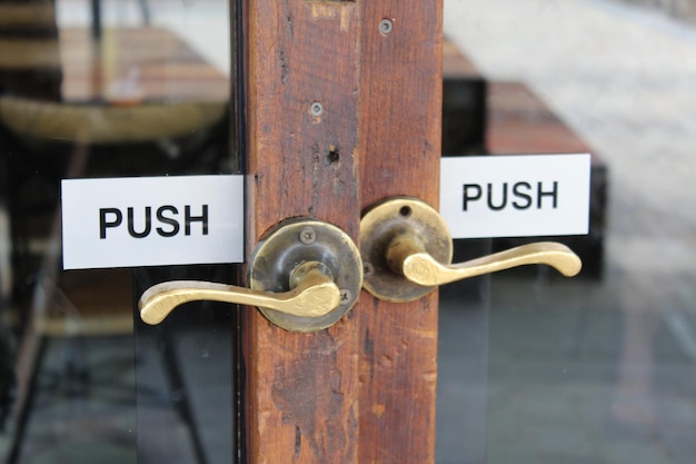 close-up of information sign on wooden door