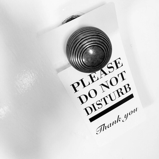 close-up of information tag hanging on doorknob